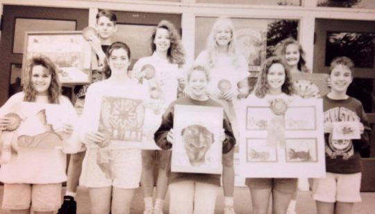 Young Dawn Roeske in a newspaper clipping, proudly holding an award-winning painting.